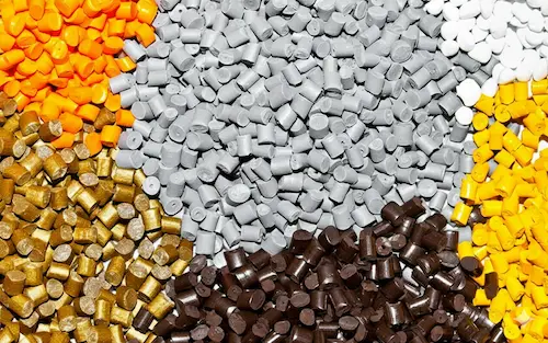 High-quality ABS plastic resin granules used as a rigid substrate in the 2-shot injection molding process for impact-resistant parts.